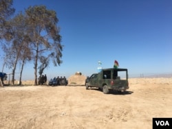 Iraqi Kurdish Peshmerga standing near one of the their lookout posts that straddles the frontline against the Islamic State in the area of Makhmour. Makhmour is expected to be one of the staging points for Iraqi and Peshmerga forces to advance on Mosul.