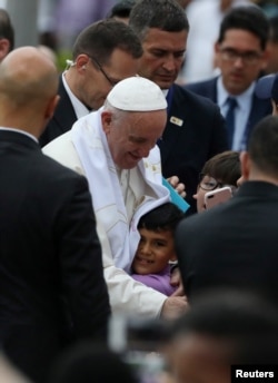 Pope Francis greets a child during a visit to the cross of the reconciliation at Fundadores park in Villavicencio, Colombia, Sept. 8, 2017.