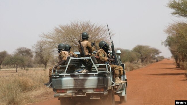 FILE - Soldiers from Burkina Faso patrol on the road of Gorgadji in the Sahel area, Burkina Faso, March 3, 2019.