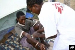 A MSF medical worker gives an injection to a young man in Zimbabwe