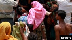 People from a Rohingya internally displaced persons (IDP) camp board a vehicle to their camp after waiting out cyclone Mahasen in a mosque outside of Sittwe, Burma, May 17, 2013. 