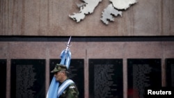 FILE - Argentine Falkland War veteran Jose Gonzalez pays homage to Argentine soldiers who died in the 1982 conflict between Britain and Argentina in the Falkland Islands, known to Argentines as 'Malvinas' at the memorial dedicated to them in Buenos Aires, April 2, 2016. 
