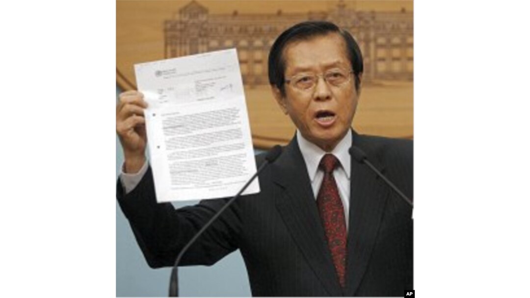 Taiwan's FM Timothy Yang holds evidence during an impromptu press conference to denounce Beijing's move in pressuring the World Health Organization to recognize Taiwan as part of China, in Taipei, Taiwan, May 10, 2011