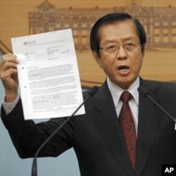 Taiwan's FM Timothy Yang holds evidence during an impromptu press conference to denounce Beijing's move in pressuring the World Health Organization to recognize Taiwan as part of China, in Taipei, Taiwan, May 10, 2011