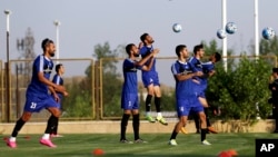 FILE - Iran's national soccer team is seen training in Tehran, Iran, Sept. 4, 2017. Iranian athletes, and soccer players in particular, are now facing official pressure to display images of Iranian soldiers killed in action in Iran and Syria, in an apparent attempt to shape public opinion in favor of Tehran's military involvement in the two countries.