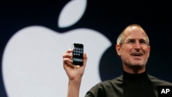 Apple CEO Steve Jobs holds up the first iPhone during his keynote address at MacWorld Conference & Expo in San Francisco, Tuesday, Jan. 9, 2007.