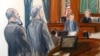 In this courtroom sketch, from left, Suleiman Abu Ghaith stands next to his attorney, Stanley Cohen, as courtroom deputy Andrew Mohan, reads the verdict and Judge Lewis Kaplan, right, listens, March 26, 2014 at federal court in New York.