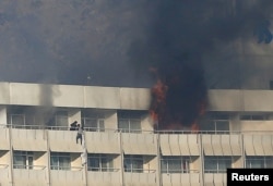 A man tries to escape from a balcony at Kabul's Intercontinental Hotel during an attack by gunmen in Kabul, Afghanistan, Jan. 21, 2018.