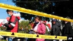 People line up to be tested for COVID-19, in the Benito Juarez borough of Mexico City, Jan. 15, 2022.