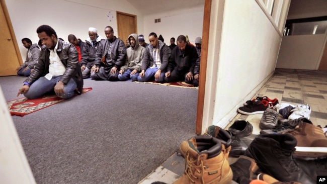 FILE - Muslim worshippers pray inside a makeshift mosque above a convenience store and market that caters to Somalis in Fort Morgan, Colo., Jan. 8, 2016. Fort Morgan, a town of roughly 12,000 people, has about 1,200 Somali immigrants.