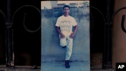 This Oct. 31, 2018 photo shows an undated family photo of Wilmer Gerardo Nunez as a young adult, at his mother's home in the Ciudad Planeta neighborhood of San Pedro Sula, Honduras. 