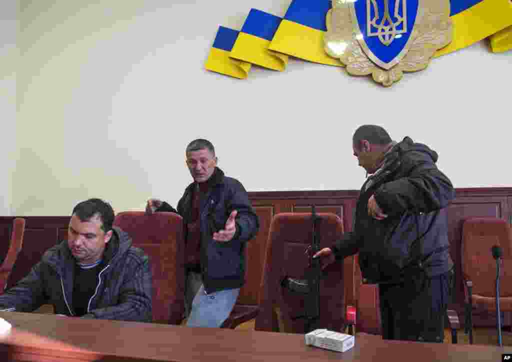 Pro-Russian activists are seen in a hall inside the building of the Ukrainian regional office of the security service in Luhansk, west of the Russian border, Ukraine, April 7, 2014.