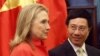 FILE - In this photo from July 2012, Vietnam's Foreign Minister Pham Binh Minh and then-U.S. Secretary of State Hillary Clinton prepare to walk to the meeting room at the Government Guest House in Hanoi.