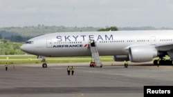 Airport workers are seen near the Air France Boeing 777 aircraft that made an emergency landing at Moi International Airport in Kenya's coastal city of Mombasa, Dec. 20, 2015.