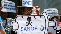 Protesters rally at the Sanofi Pasteur office in suburban Taguig city to protest the drug company's deal with the government for the anti-dengue vaccine Dengvaxia, March 5, 2018, east of Manila, Philippines. The vaccine was administered to more than 830,000 school children and adults before being pulled from the shelves after new study showed it posed risks of severe cases in people without previous infection.