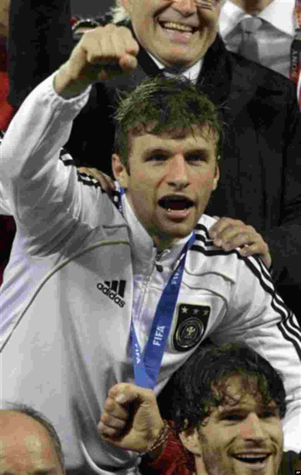 Germany's Thomas Mueller celebrates his side's 3-2 win after the World Cup third-place soccer match between Germany and Uruguay at Nelson Mandela Bay Stadium in Port Elizabeth, South Africa, Saturday, July 10, 2010. (AP Photo/Gero Breloer)