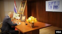 Vice President Joe Biden signs a book of condolences for His Majesty King Bhumibol Adulyadej