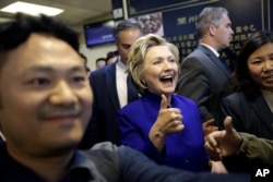 Democratic presidential candidate Hillary Clinton talks with patrons at a restaurant in the Flushing section of Queens in New York, April 18, 2016.