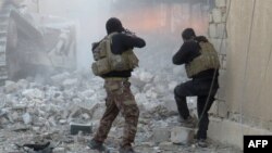FILE - Iraqi forces secure an area in Ramadi, the capital of Iraq's Anbar province, on January 10, 2016, after retaking the city from Islamic State jihadists.
