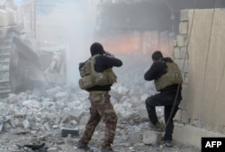 FILE - Iraqi forces secure an area in Ramadi, the capital of Iraq's Anbar province, on January 10, 2016, after retaking the city from Islamic State (IS) group jihadists.