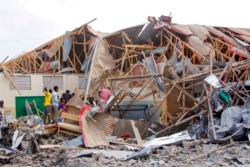 People search for bodies at the scene of a blast in Mogadishu, Somalia, Nov. 25, 2021.