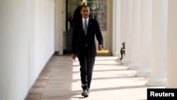 President Barack Obama walks from his residence to the Oval Office at the White House in Washington, Sept. 10, 2013, ahead of an address on the war in Syria. 