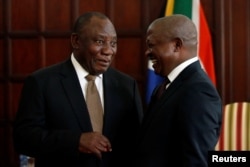 FILE - South African President Cyril Ramaphosa, left, talks with Deputy President David Mabuza in Pretoria, May 28, 2019.