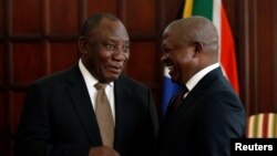 FILE - South African President Cyril Ramaphosa, left, talks with Deputy President David Mabuza in Pretoria, May 28, 2019. 