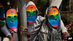 Kenyan gays, lesbians and others supporting their cause, wear masks to preserve their anonymity as they stage a protest against Uganda's increasingly tough stance against homosexuality, outside the Uganda High Commission in Nairobi, Kenya, Feb. 10, 2014. 