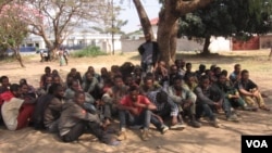 Illegal Ethiopian immigrants await trial outside the Karonga Court, Malawi, Sept. 24, 2014. (Tiwonge Kumwenda/VOA)