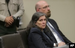 FILE - Louise Turpin and her attorney, Jeff Moore, appear in court for a conference about their case in Riverside, Calif., Feb. 23, 2018.