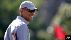 President Barack Obama smiles while golfing, Aug. 12, 2015, at Farm Neck Golf Club in Oak Bluffs, Massachusetts, on the island of Martha's Vineyard. 