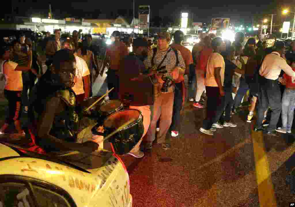 Protesters gather along West Florissant Avenue during a demonstration in Ferguson, Aug. 11, 2015.