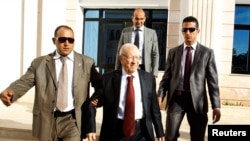 FILE - Beji Caid Essebsi (C), former Tunisian PM and leader of Nida Touns (Call of Tunisia) secular party, leaves after talks between ruling Islamists and the opposition to pave the way for the formation of a transitional government, Tunis, Nov. 4, 2013.