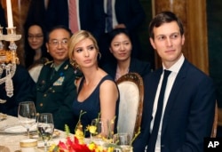 FILE - Ivanka Trump, second from right, the daughter and assistant to President Donald Trump, is seated with her husband, White House senior adviser Jared Kushner, right, during a dinner with President Donald Trump and Chinese President Xi Jinping at Mar-a-Lago in Palm Beach, Florida, April 6, 2017. Earlier in the day, Ivanka Trump's company received provisional approval from the Chinese government for three new trademarks, winning monopoly rights to sell Ivanka brand jewelry, bags and spa services in the world's second-largest economy.