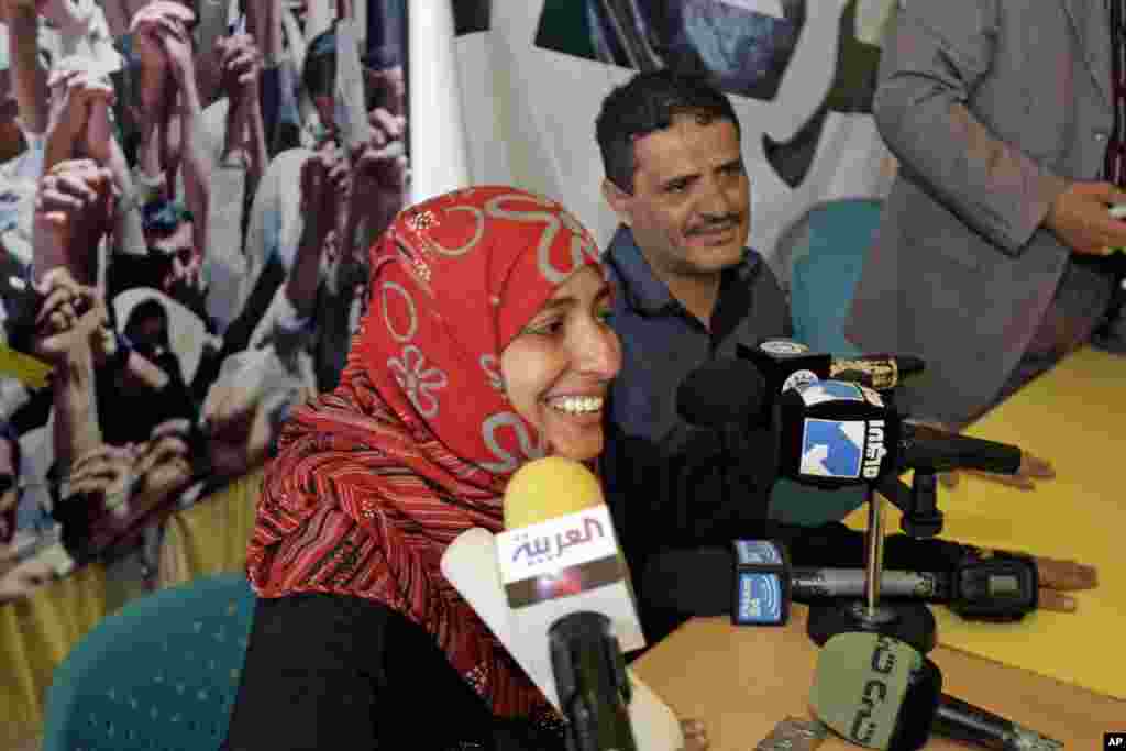 October 7, 2011: Yemeni activist Tawakkul Karman, next to husband, Mohammed Esmaeel al-Nehmy (R), speaks to journalists in Sanaa after the announcement that she had won the 2011 Nobel Peace Prize with&nbsp; Liberian President Ellen Johnson Sirleaf and Lib