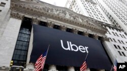 An Uber banner hangs on the facade of the New York Stock Exchange, May 10, 2019. 