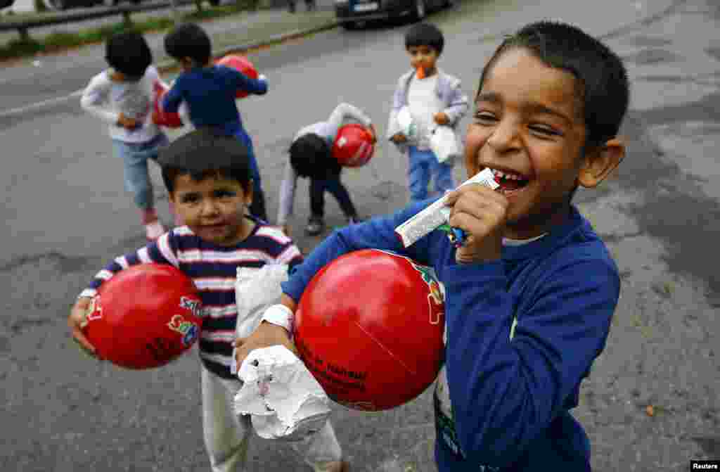 Children play with the gifts they got for the Muslim holiday Eid al-Adha from well-wishers of a local muslim community in Hanau, Germany.