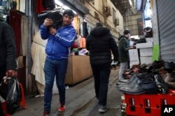 FILE - People conduct their business at the Grand Bazaar in Tehran, Iran, Feb. 7, 2019.