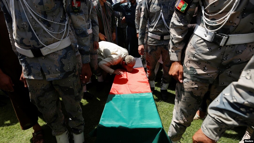 A relative kisses the coffin of an Afghan soldier, who was killed last night during a gun fight between Afghan border forces and Pakistani forces in Torkham, during his funeral in Nangarhar province, Afghanistan, June 14, 2016.