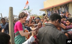 Congress party General Secretary and eastern Uttar Pradesh state in-charge Priyanka Gandhi Vadra, left, meets party supporters before undertaking a steamer ride in the River Ganges from Manaiya, 25 kilometers (15.6 miles) from Prayagraj, India, March 18, 2019.