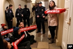 Diana Colin, right, with the Coalition for Humane Immigrant Rights, shouts, "McCarthy you have no heart," as the group from California protests outside the office of House Majority Leader Kevin McCarthy, Jan. 18, 2018, on Capitol Hill in Washington, in favor of the Deferred Action for Childhood Arrivals program.