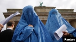 Protesters dressed in burqas attend a rally in front of the Brandenburg Gate, in Berlin, Germany, Sept. 20, 2008. If Germany enacts Merkel's ban, it would join the three other European countries - France, Belgium and the Netherlands - which aleady have their own specific bans on face-covering veils.