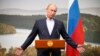 Russian President Vladimir Putin gestures while speaking during a media conference after a G8 summit at the Lough Erne golf resort in Enniskillen, Northern Ireland, June 18, 2013. Putin hosts this year's G8 summit in Sochi, Russia, June 4-5. 