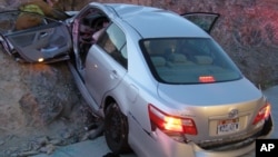 FILE - In this photo released by the Utah Highway Patrol, a Toyota Camry is shown after it crashed as it exited Interstate 80 in Wendover, Utah. 