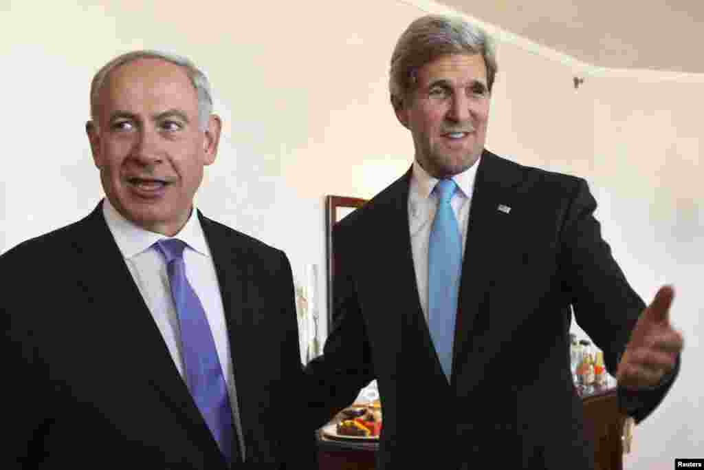 U.S. Secretary of State John Kerry gestures as he meets Israeli Prime Minister Benjamin Netanyahu in Jerusalem, June 28, 2013. 
