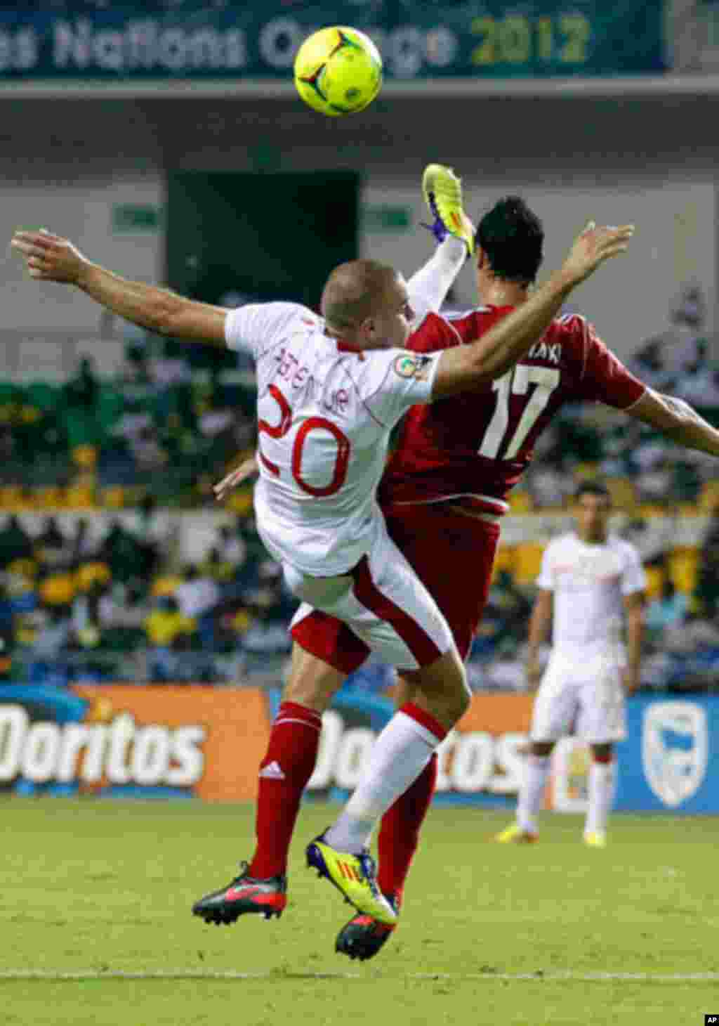 Tunisia's Aymen jumps for the ball with Morocco's Marouane during their African Cup of Nations soccer match in Libreville
