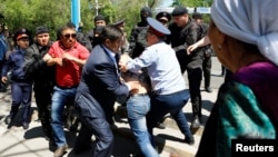 File - Riot police officers detain demonstrators during a protest against President Nursultan Nazarbayev's government and the land reform it has proposed, in Almaty, Kazakhstan, May 21, 2016.