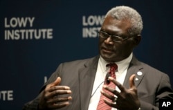 Manasseh Damukana Sogavare, Prime Minister of Solomon Islands, attends a Lowy Institute event in Sydney, in August, 2017, (AP Photo/Rick Rycroft)