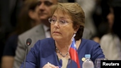 FILE - Chile's President Michelle Bachelet attends a session of the Summit of Heads of State of MERCOSUR and Associated States in Luque, Paraguay, Dec. 21, 2015.